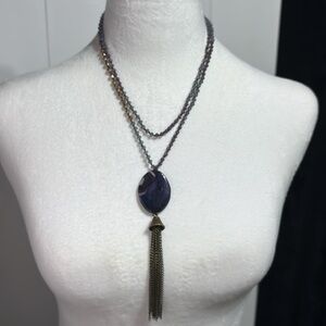 Long purple/blue/gold beaded necklace with large purple stone, gold tone tassel